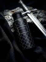 Maison Asrar Vanguard black bottle centered on a clean background with subtle cedarwood positioned directly behind it