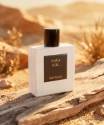 Rayhaan Nava Sol perfume with minimal sapodilla fruit and violet flowers artistically arranged exclusively on the left and right sides of the bottle.